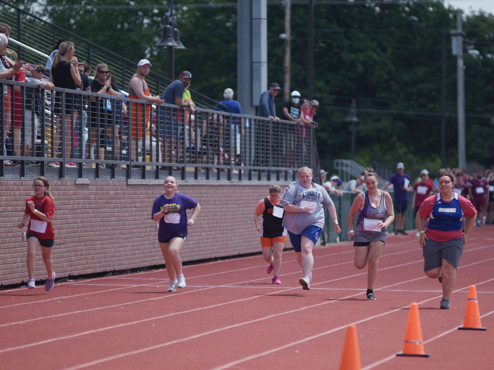 Special Olympic athletes race down the track